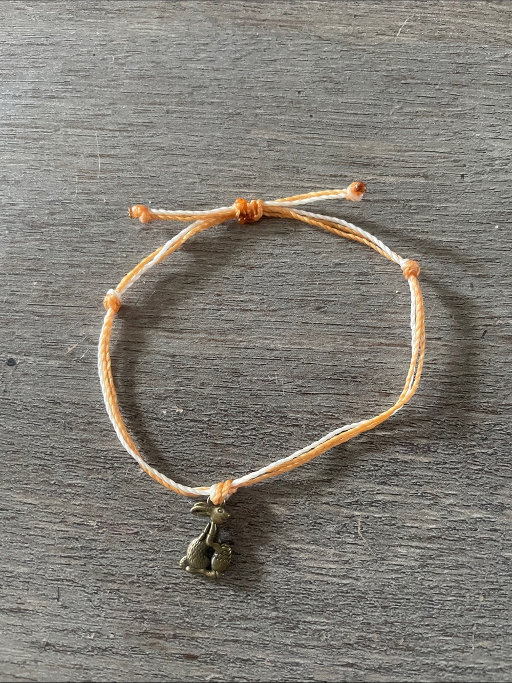 Handcrafted Orange and White Braided Bracelet with Bunny Charm